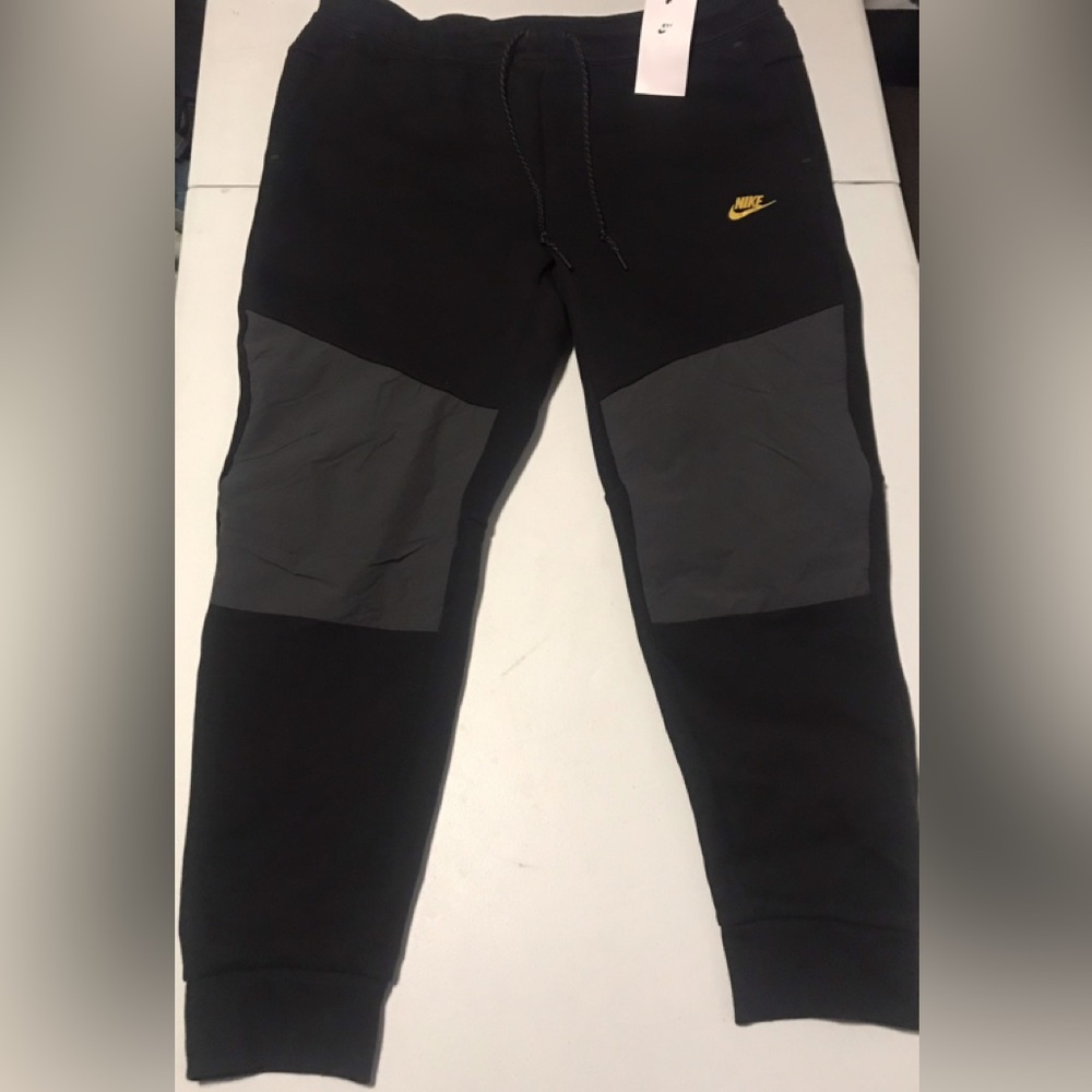Nike Black Joggers with Gray Knee Panels and Gold Logo